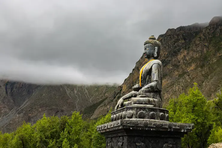 A statue of Gautam Buddha inside Muktinath Temple, Nepal, surrounded by traditional religious decor and Himalayan ambiance.