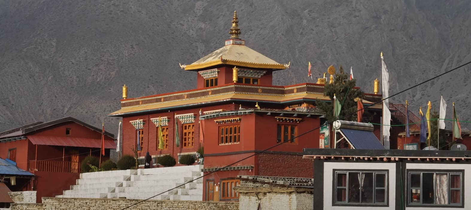 Colorful Buddhist monastery in Muktinath set against a mountainous backdrop